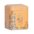 Orangefarbene Teedose mit Blumenmuster